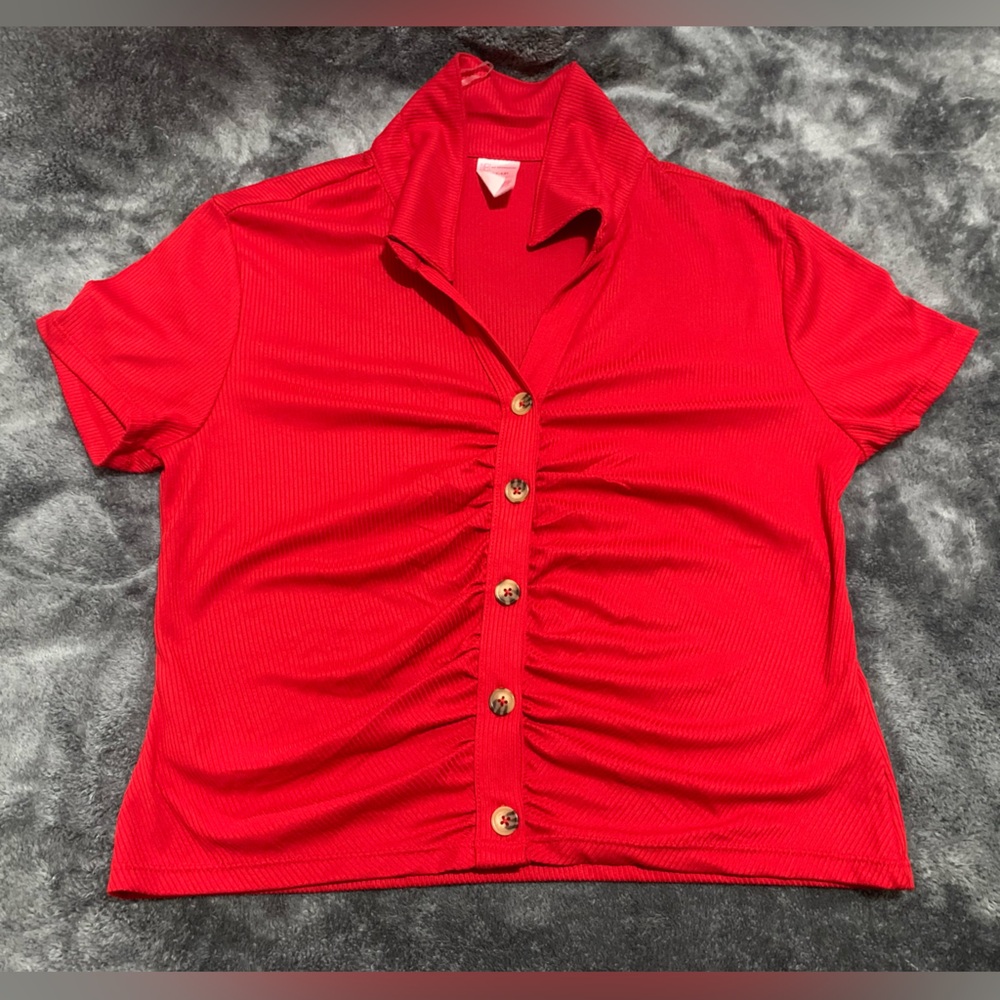 Red button polo shirt in the size extra large